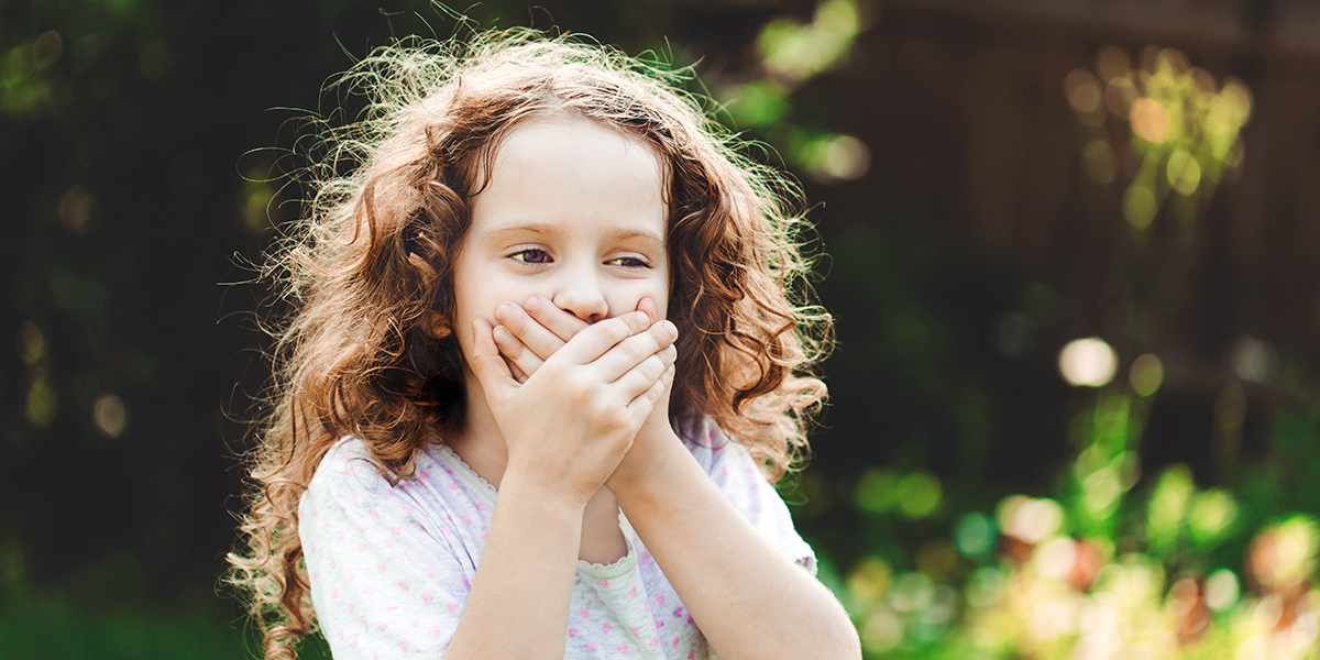 CHILD COVERING MOUTH