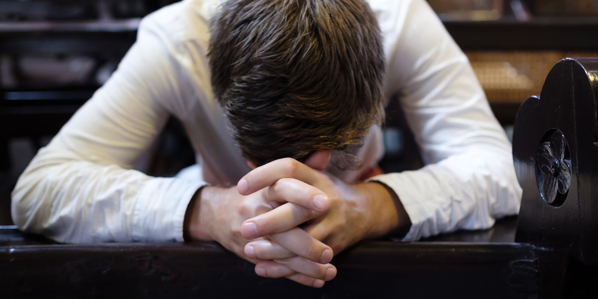 MAN,PRAYING,CHURCH